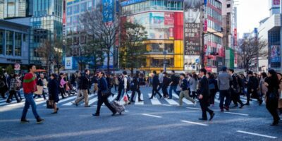 Busy commuters in Japan pass by outdoor advertising, Photo by Cory Schadt on Unsplash